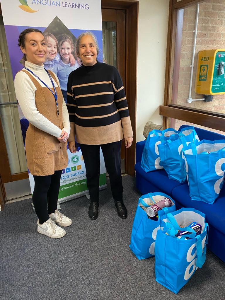 Office Manager, Iona with Village Charity Director, Jas Hill at Stapleford School with a dozen or so food bags
